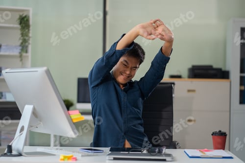 Preview: Male businessman is doing a stretchy posture due to sitting in the office for too long