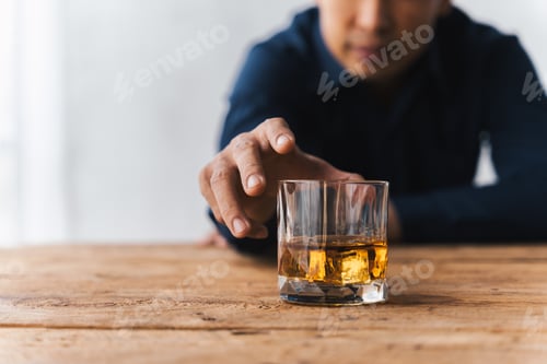 Preview: drunk asian man hold whisky glass addicted alcohol need therapy.