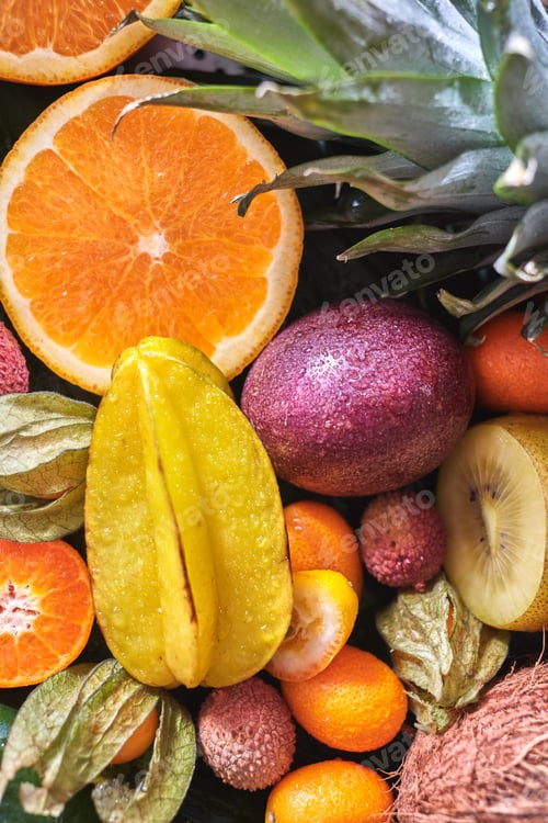 Preview: Natural organic background from exotic fruits carambola, half of orange, passion fruit, pineapple