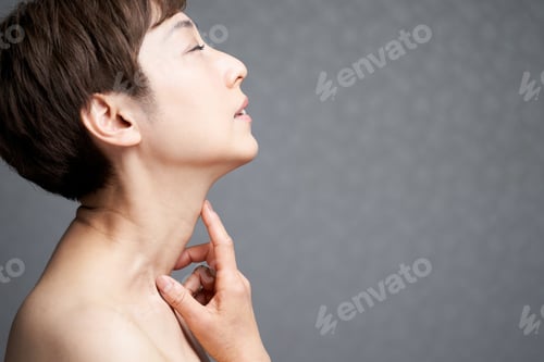 Preview: Middle-aged Japanese woman holding her neck
