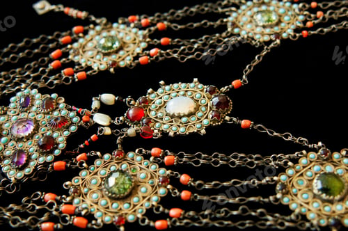 Preview: Vintage, fancy jewelry pendant with precious stones isolated on the black background