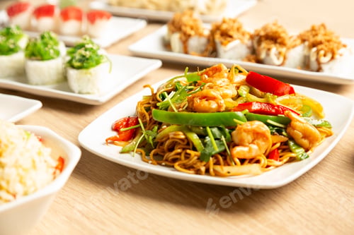 Preview: Table with Japanese food sushi, noodles and rice with vegetables.