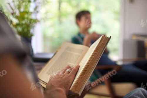 Preview: A person sitting reading a book.