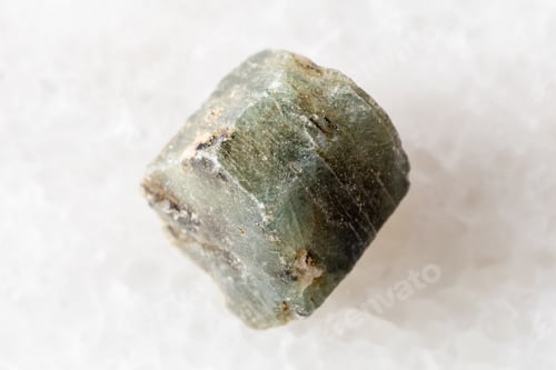 Preview: raw green sapphire corundum mineral on white