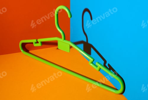 Preview: Green hanger on flat colors background. Red, blue, yellow .