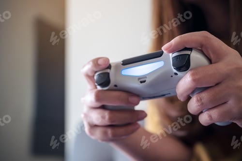 Preview: hands holding the game controller while playing games