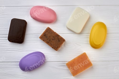 Preview: Top view many different spa soaps on white wood.