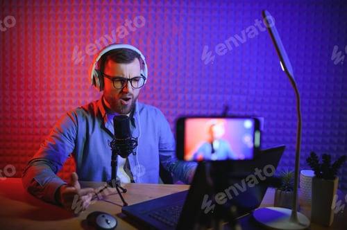 Preview: vlogger using smartphone to film podcast in studio.