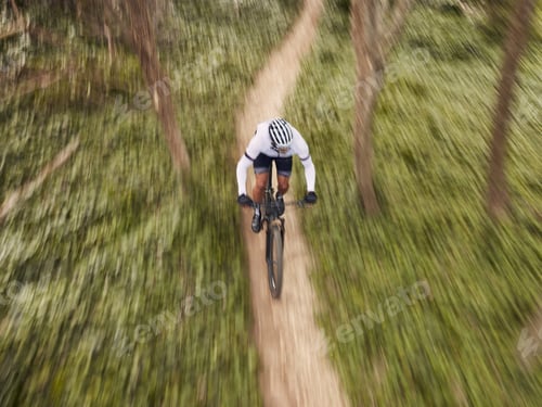 Preview: Speed, nature and cyclist on bicycle from above with helmet, exercise adventure trail and forrest f