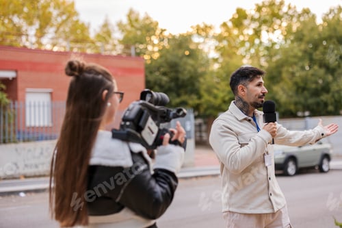 Preview: Reporter presenting street news with camerawoman filming