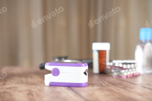 Preview: pulse oximeter, medical pills and blister pack on table