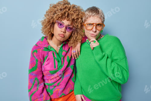 Preview: Indoor shot of displeased women feel offended and unhappy look seriously at camera wear bright