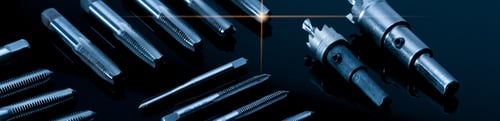 Preview: Closeup straight flute tap tip and hole saw on dark background. Industrial tapping tools. Carbide