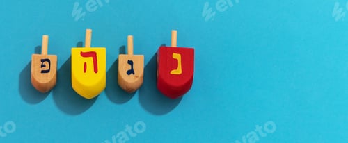 Preview: Top view of Hanukkah dreidel in a blue background - a game played during Jewish holidays