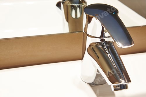 Preview: Chrome metallic washbasin sink tap detail. Bathroom decoration