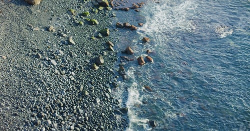 Preview: Peaceful ocean view, rocky volcanic beach with black stones, Tenerife. Sunset.
