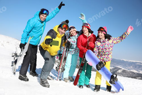 Preview: Group of friends taking selfie outdoors. Winter vacation