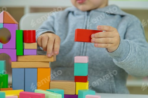 Preview: Boy playing with toys in the room. Selective focus