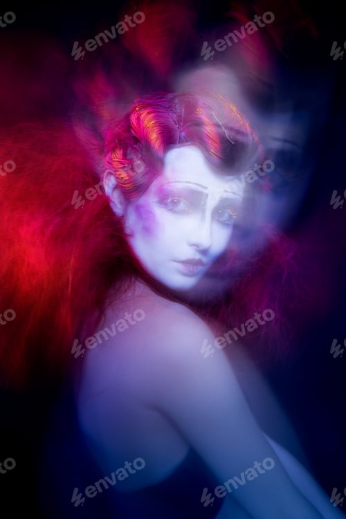 Preview: High Fashion model woman in colorful bright lights posing in studio