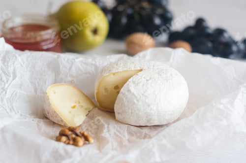 Preview: Camembert cheese with white mold, walnuts, honey and dried fruits. Dinner or aperitif concept.