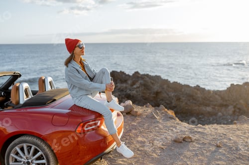 Preview: Woman traveling by car on the rocky coastline