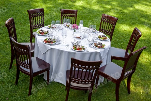 Preview: Table setting with chairs for garden banquet