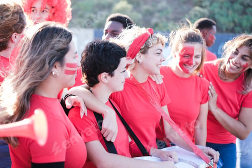 Preview: Group of soccer team fans together cheering and having a good time outdoors