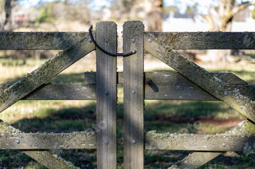 Preview: Old farm fence covered with moss on a remote country paddock