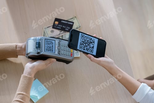 Preview: QR code payment, customer using smartphone for paying at shop.