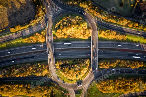 Preview: Aerial view directly above a busy motorway with a roundabout overpass bridge junction in countryside