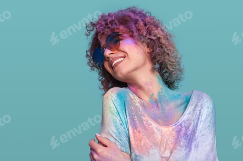 Preview: Stylish woman in Holi powder in studio