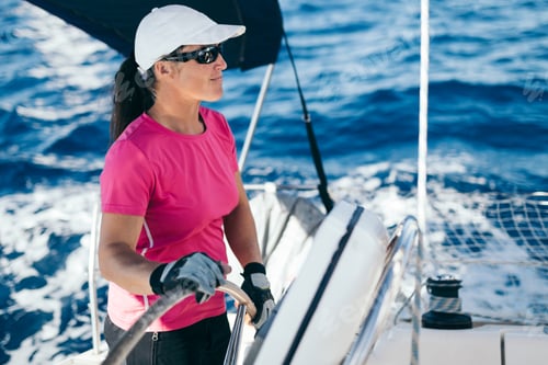 Preview: Happy strong woman sailing with her boat