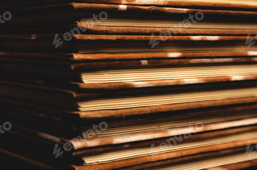 Preview: Pile of handmade notebooks isolated against black background