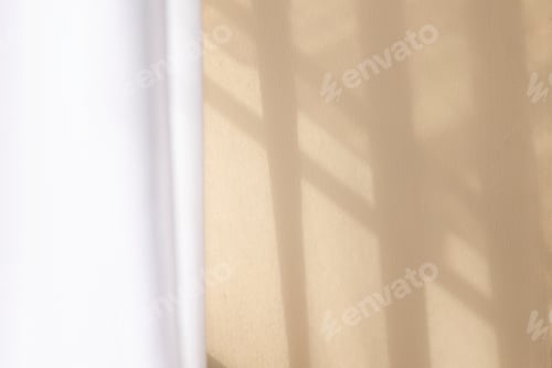 Preview: morning light through the glass window shines against the beige walls.