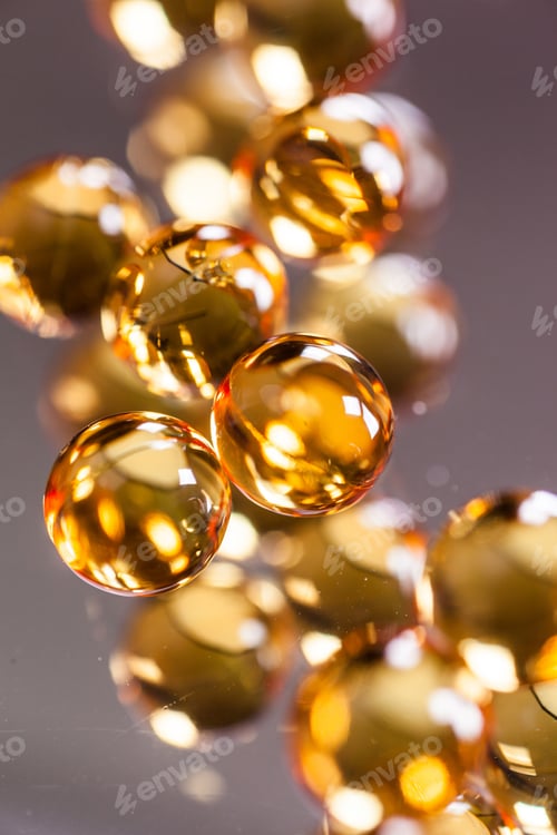 Preview: orange capsules on mirror background