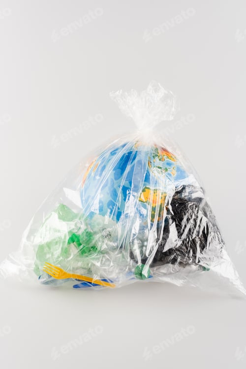 Preview: globe packed in cellophane bag with plastic rubbish on grey, ecology concept