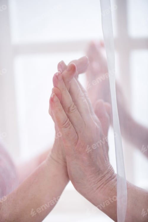 Preview: Close up view senior couple holding hands, veil in front