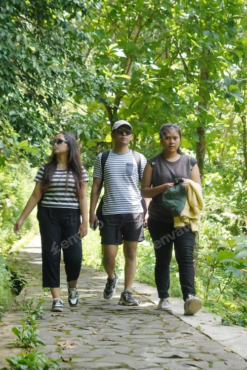 Preview: group of happy young asian indonesian people walking together on the walk path in the park