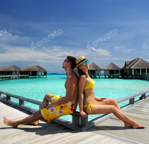Preview: Couple On A Tropical Beach Jetty At Maldives