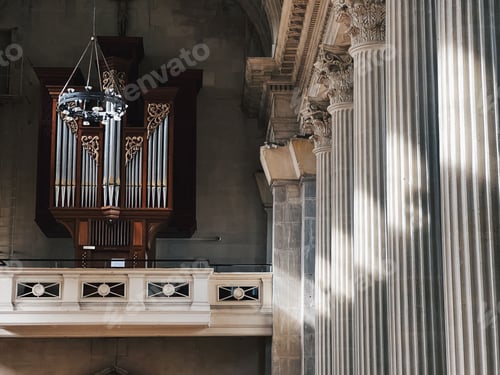 Preview: Pipe organ and stone columns with carvings in a church