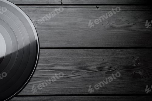 Preview: Half of LP vinyl record with blank label on black wooden background.