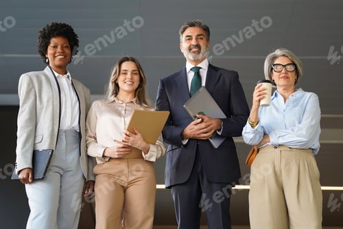 Preview: Multiethnic business team smiling together in modern office building