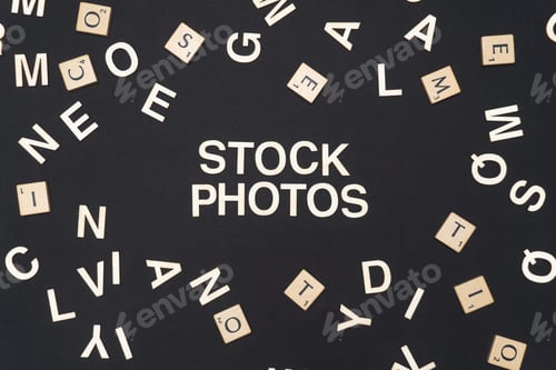 Preview: STOCK PHOTOS word written on dark paper background. STOCK PHOTOS text for your concepts