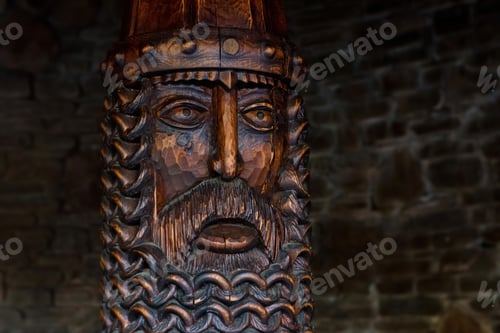 Preview: Wooden Russian sculpture on the background of a brick wall.