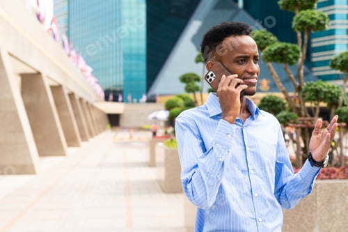 Preview: Portrait of handsome young black man outdoors in city