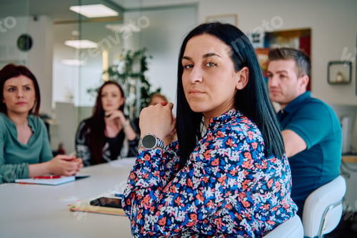 Preview: Diverse Business Team Discussing Projects in a Modern Glass Office.