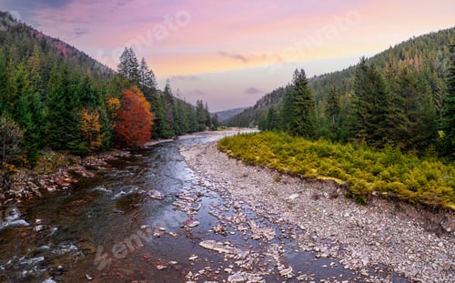 Preview: River stream running past mountain foot with autumn forest