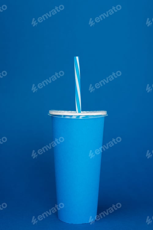 Preview: paper cup with plastic straw on blue background