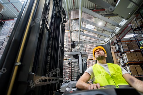 Preview: Forklift operator during work in large warehouse
