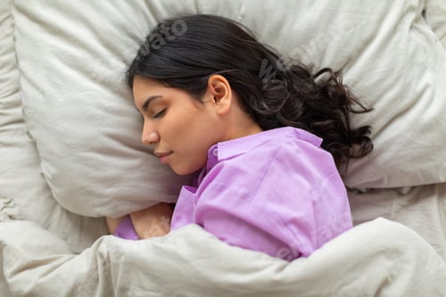 Preview: Woman Laying in Bed With Head on Pillow